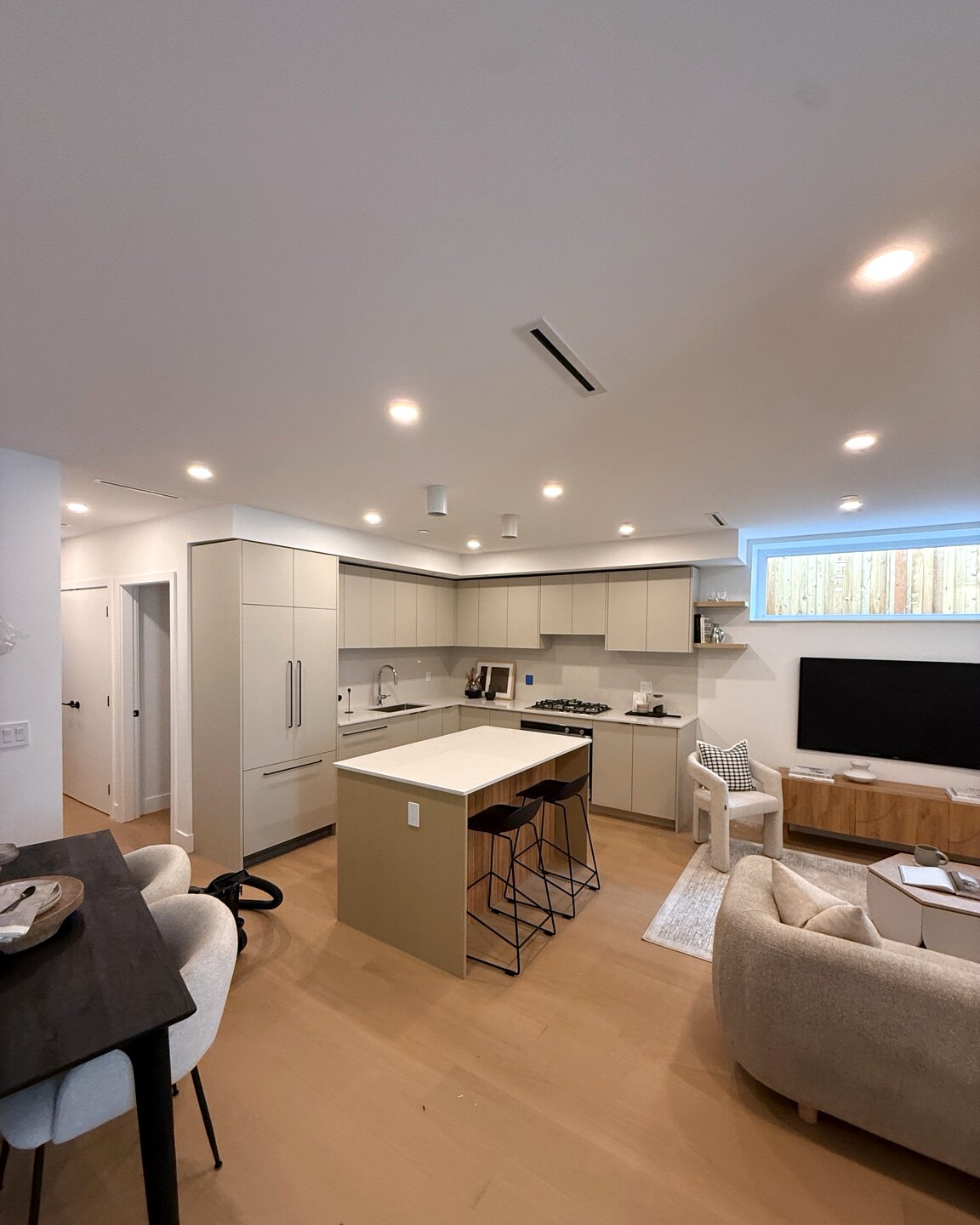 Full-height cabinetry, open shelving, and fluted island detail